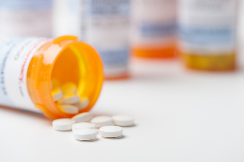 pills next to a medicine bottle