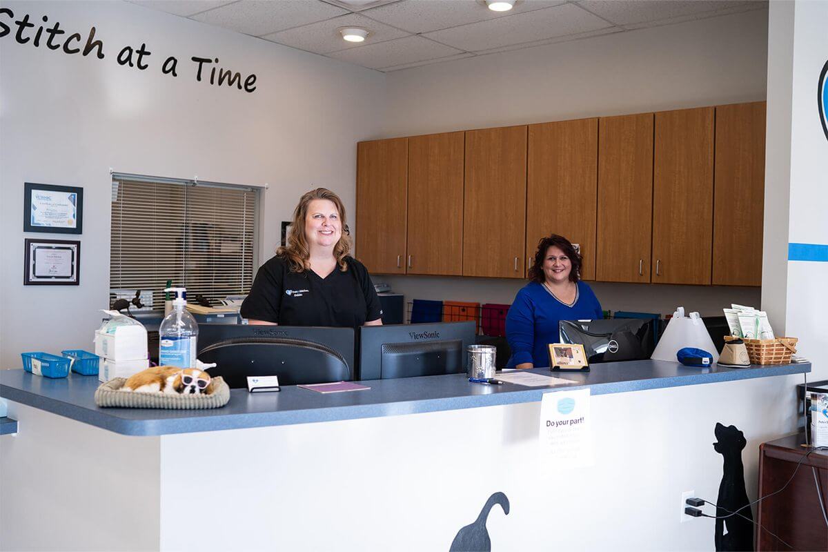 two ladies standing at front desk of vet office